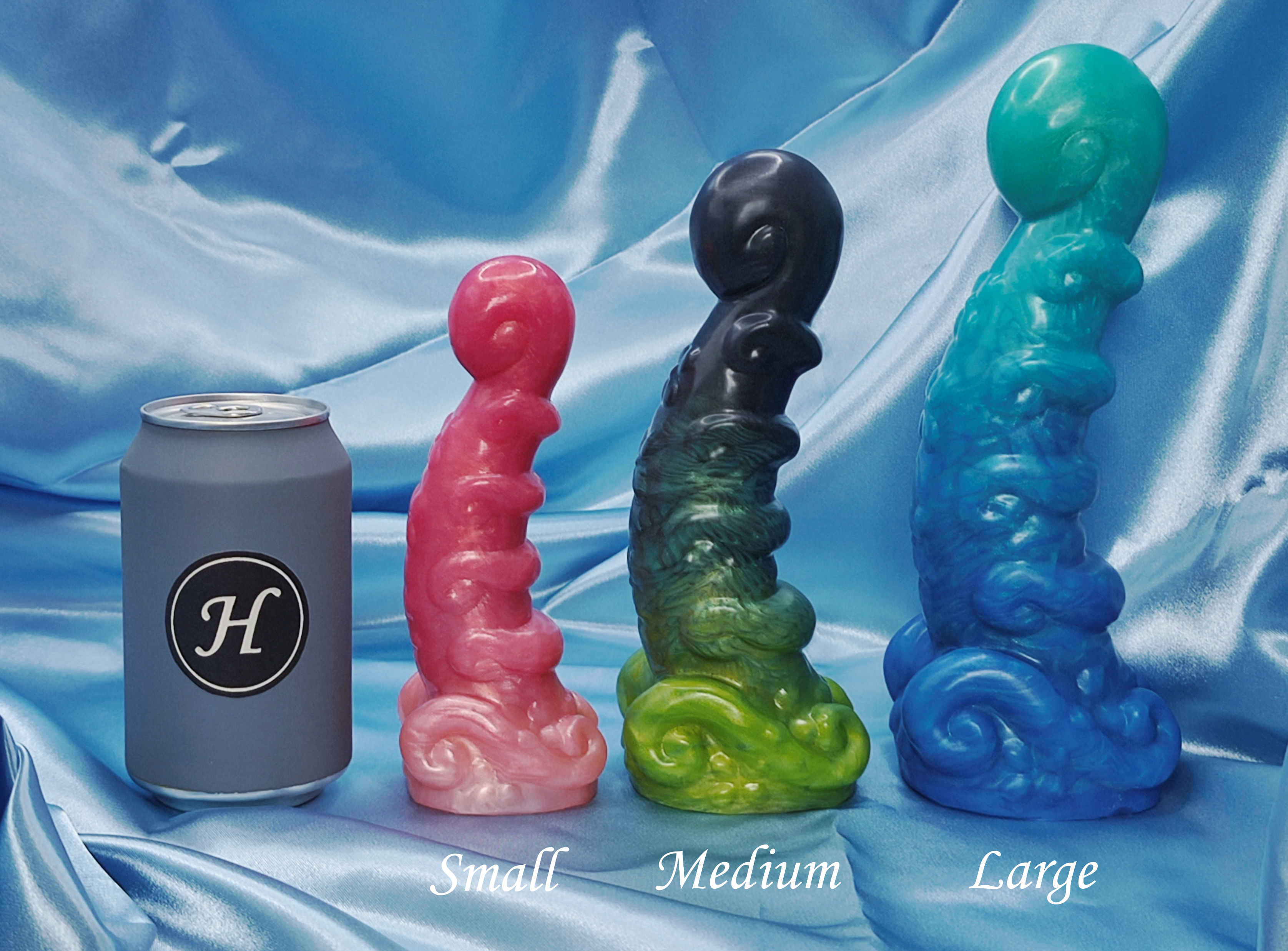 Four colorful silicone dildo next to a can on a blue fabric background